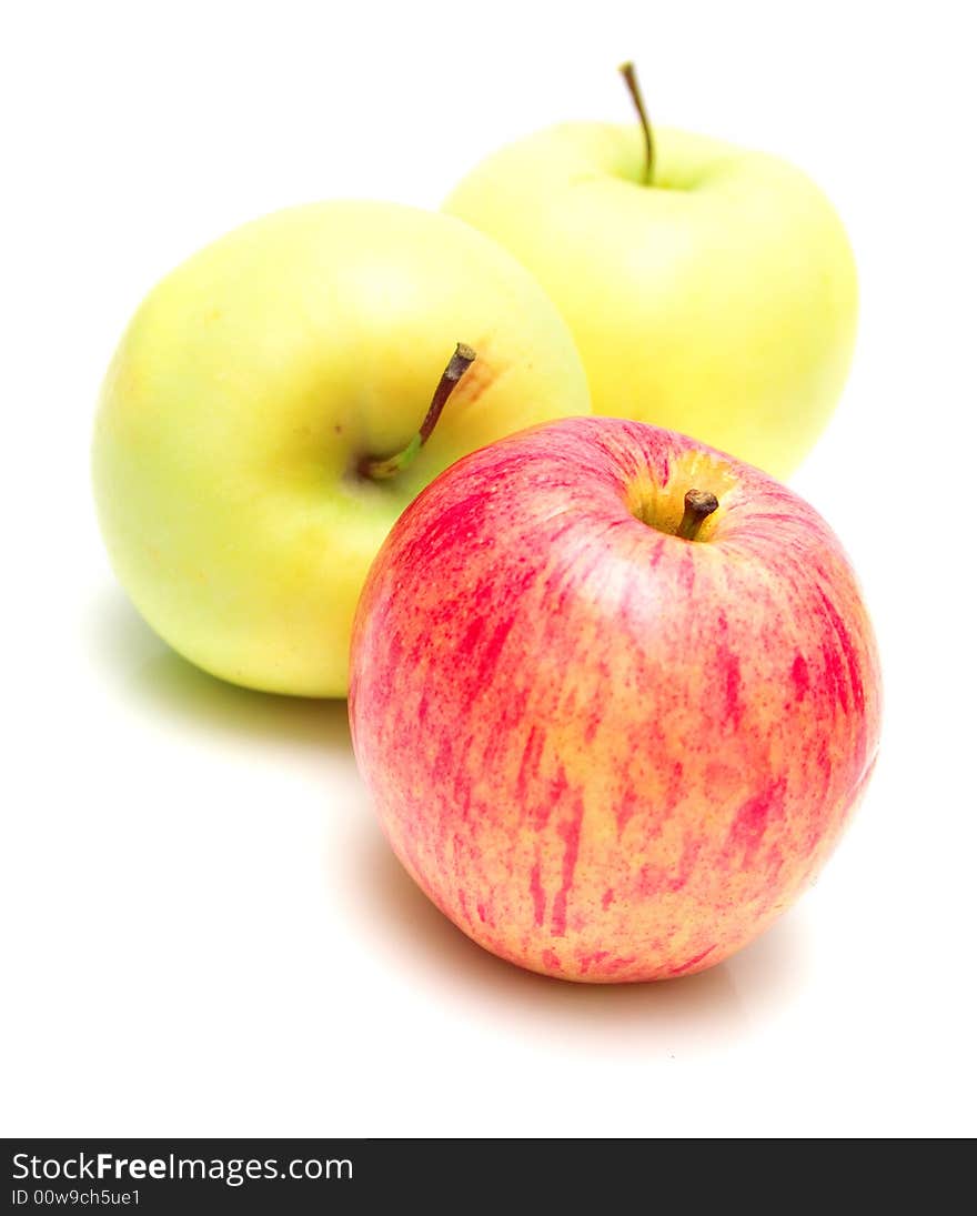 Red and yellow apples on the white background. Isolated. Shallow DOF. Red and yellow apples on the white background. Isolated. Shallow DOF