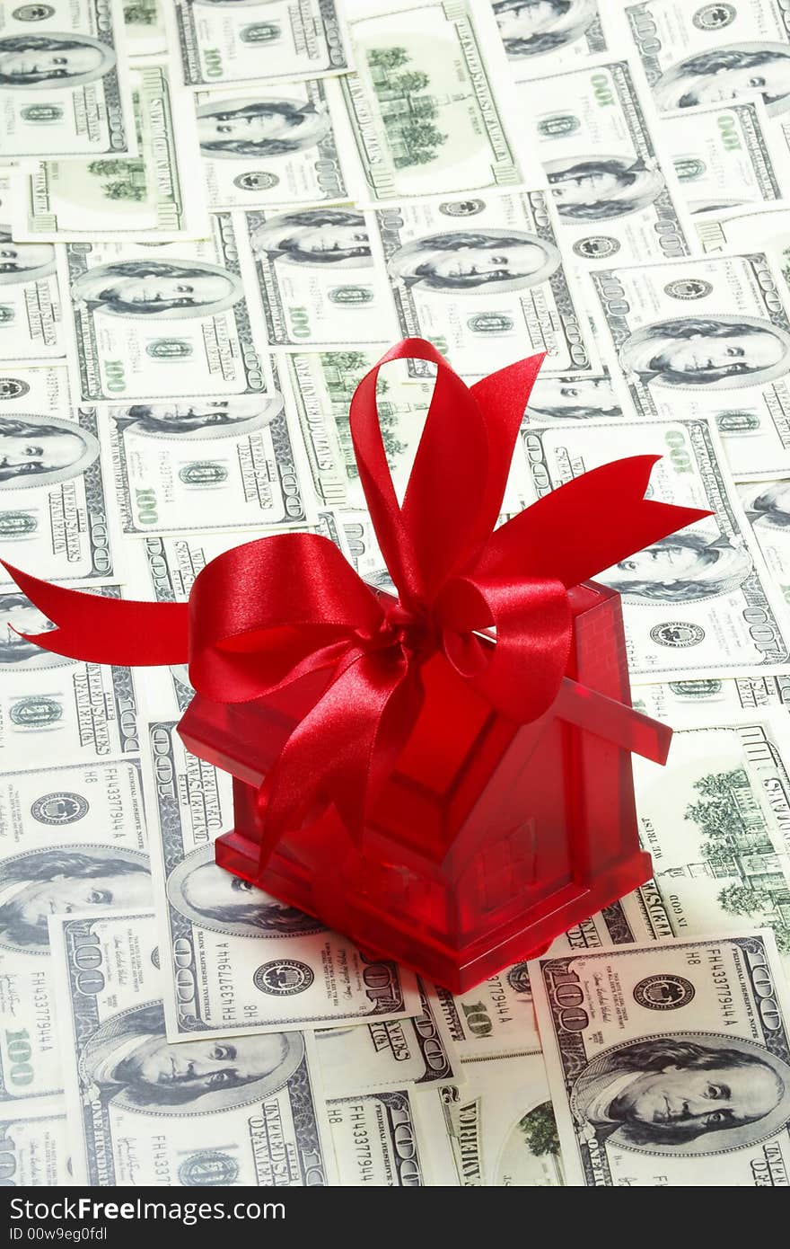 Red house with ribbon in cash background. Red house with ribbon in cash background.