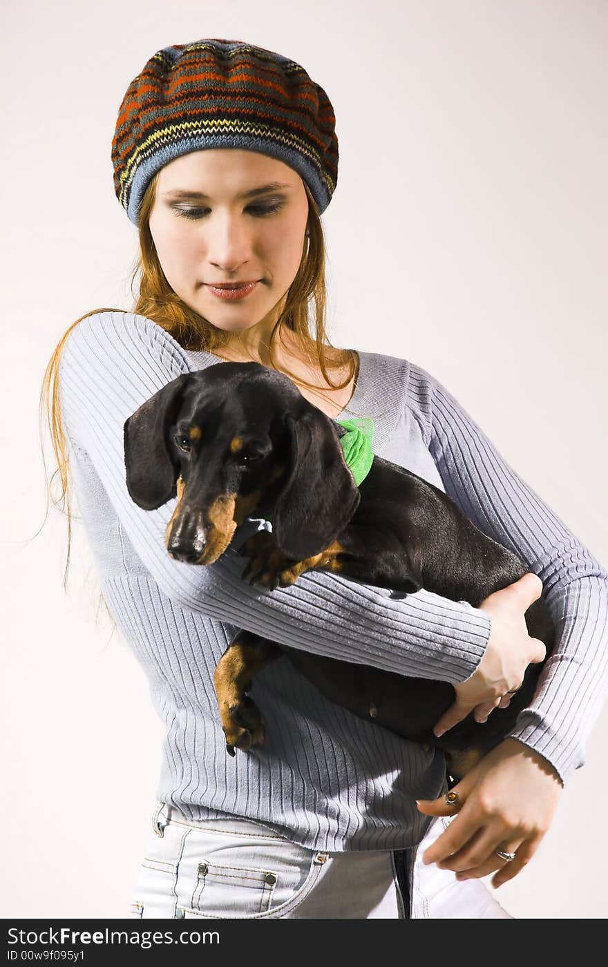 The young girl with a dog on hands