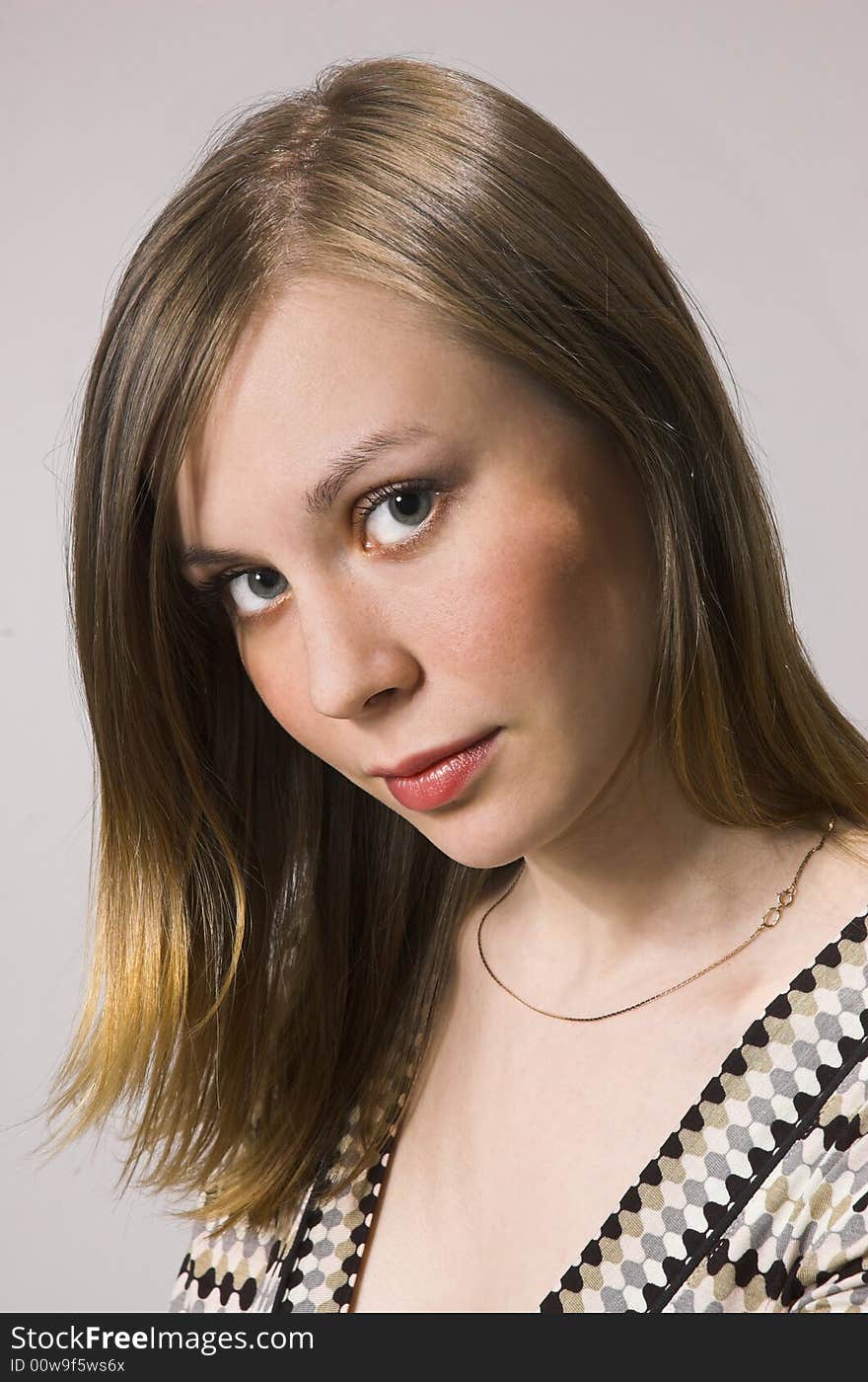 Portrait of the young girl on a grey background