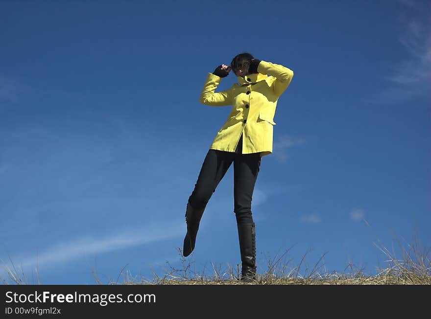 The girl dances on a background of the sky