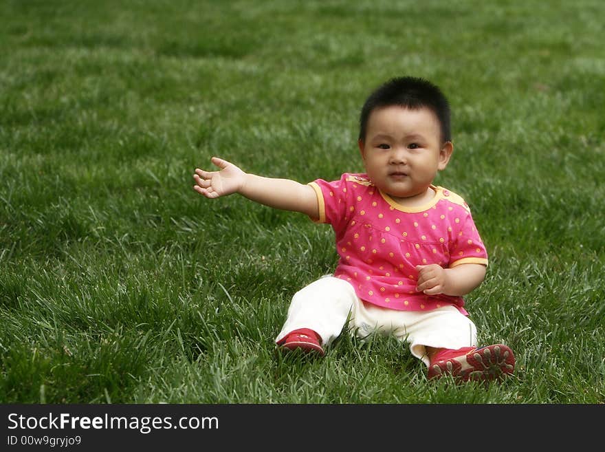 A chinese baby girl on the meadow