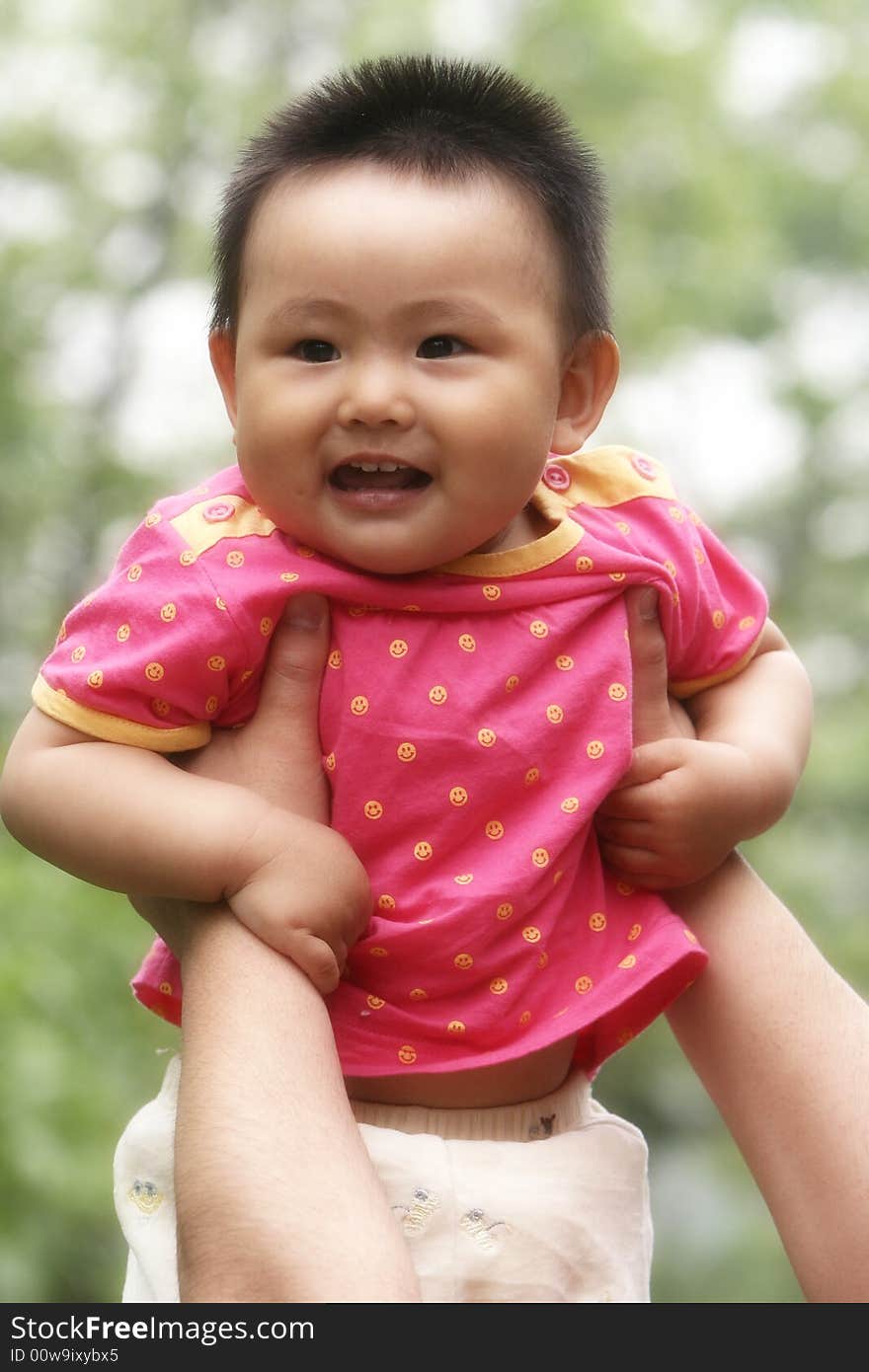 A chinese baby girl on the meadow