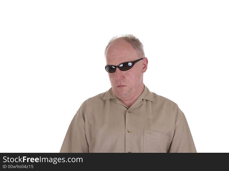 An older guy in a brown shirt wearing wrap arround sunglasses. An older guy in a brown shirt wearing wrap arround sunglasses