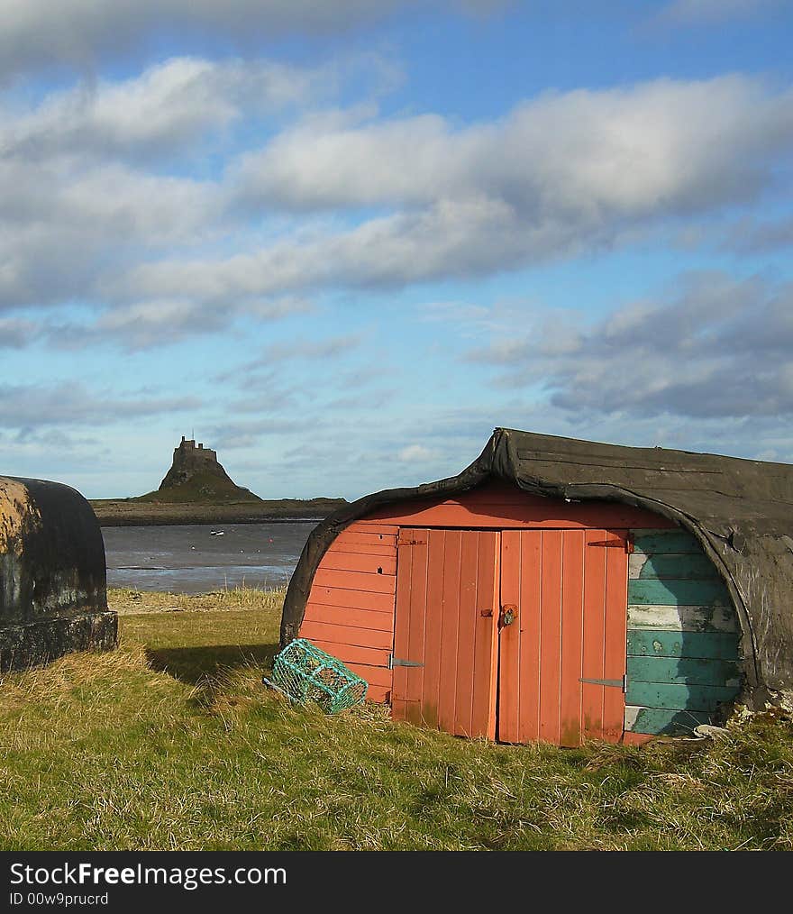 A boat shed on Lindisfarne Island, with Lindisfarne Castle in the backround.