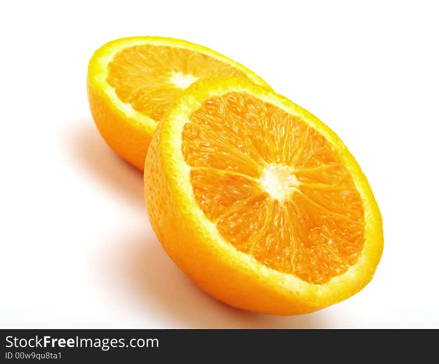 Two half fresh oranges on a white table. Two half fresh oranges on a white table