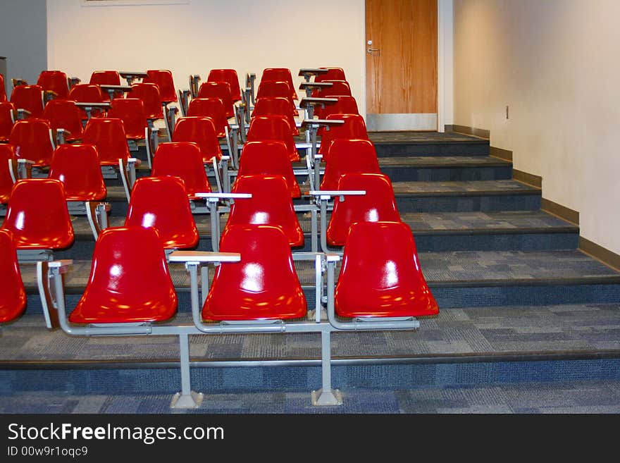 College classroom setting with red chairs