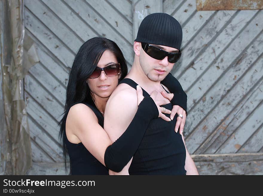 Fashion couple outside wearing sunglasses