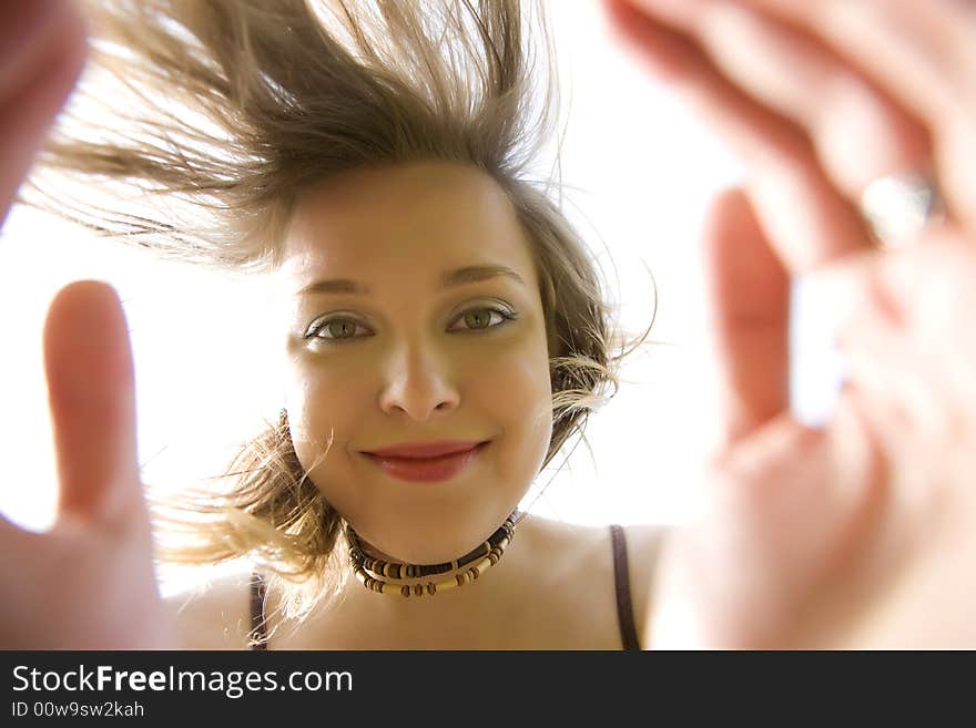 Young Woman Smiling Under The Sunlight. Young Woman Smiling Under The Sunlight