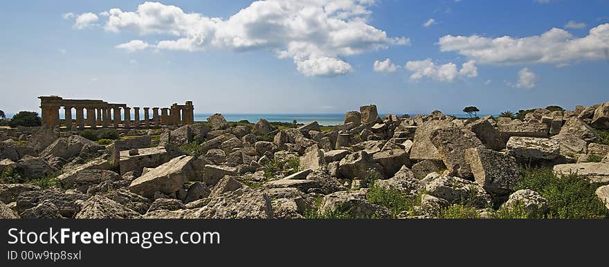 The archaeological park of Selinunte in the yellow flowers and Sea. The archaeological park of Selinunte in the yellow flowers and Sea