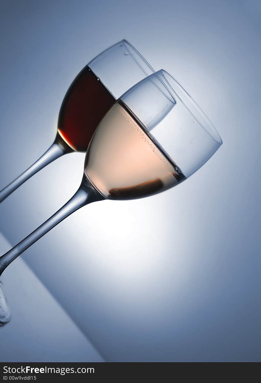 Two glasses with red and pink wine on blue tone. Two glasses with red and pink wine on blue tone