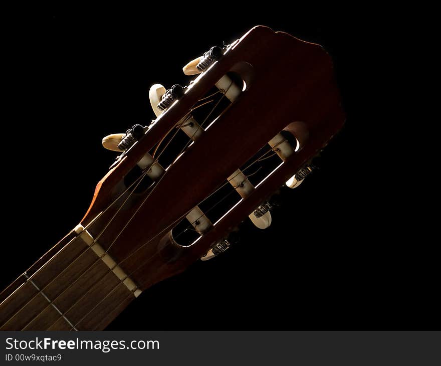 Cloze-up guitar's neck on black background