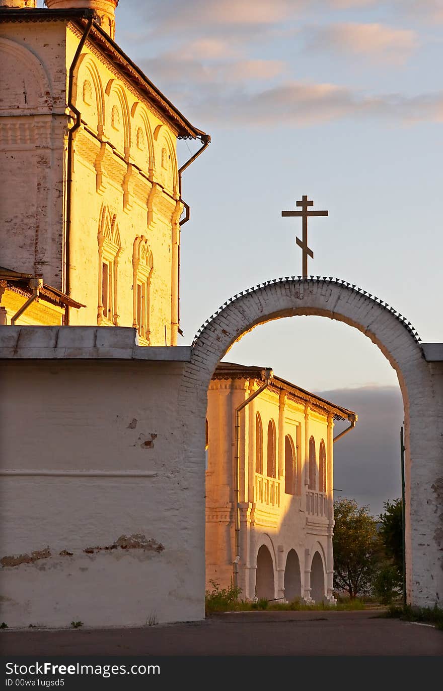 White wall of church in pink and yellow beams of the sun. White wall of church in pink and yellow beams of the sun