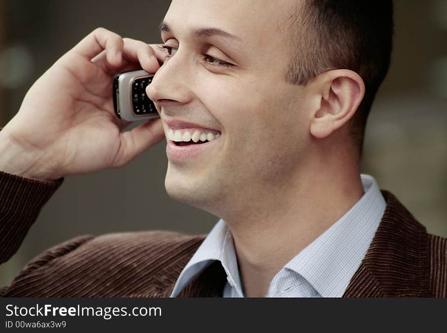 Young happy business man talking on the phone. Young happy business man talking on the phone