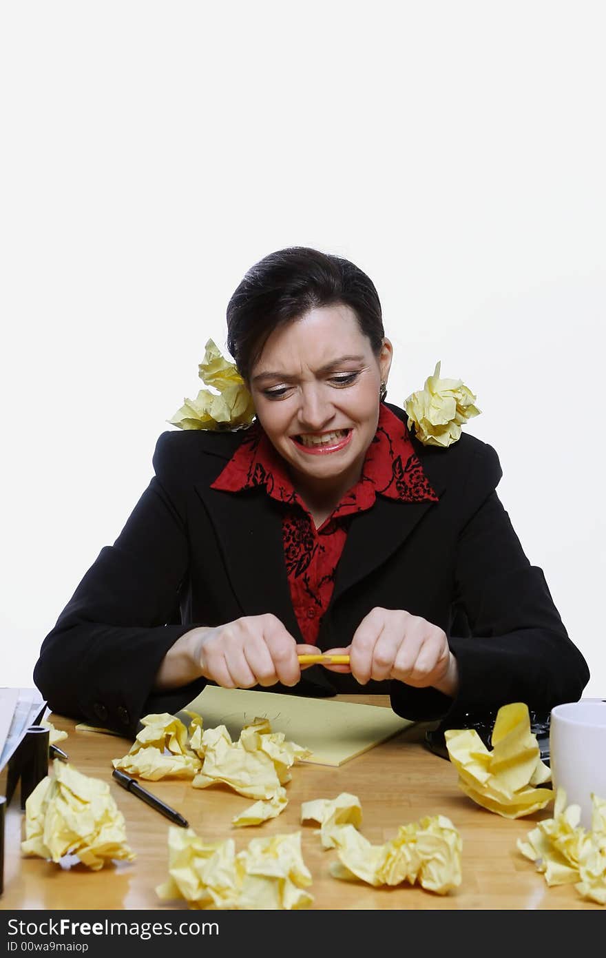 Woman in a business suit balancing a pencil under her nose surrounded by crumpled up pieces of yellow paper. Isolated against a white background. Woman in a business suit balancing a pencil under her nose surrounded by crumpled up pieces of yellow paper. Isolated against a white background