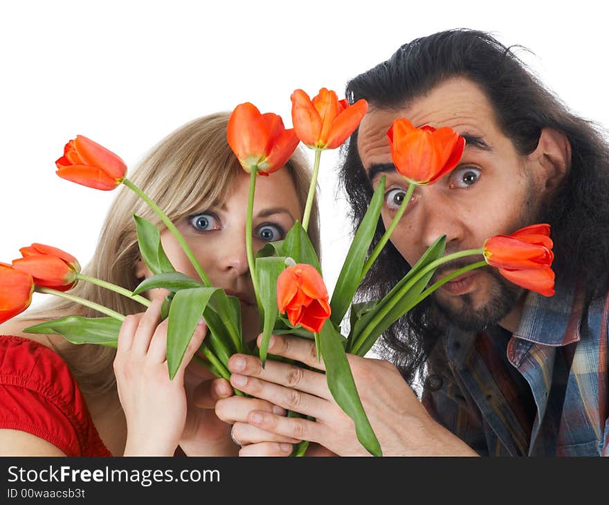 Girl and man hiding at red flowers. Girl and man hiding at red flowers