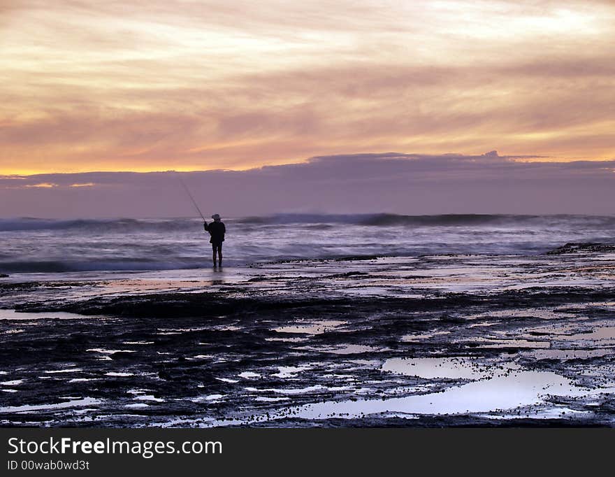 Fisherman on Mona Vale Beach in sunrise