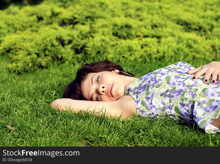 Young woman laid in grass