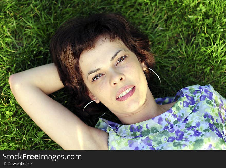 Young woman laid in grass