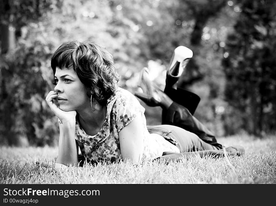 Young woman laid in grass