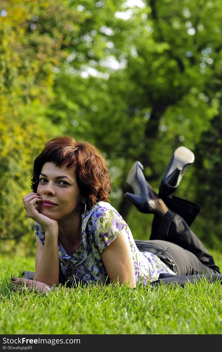 Young woman laid in grass