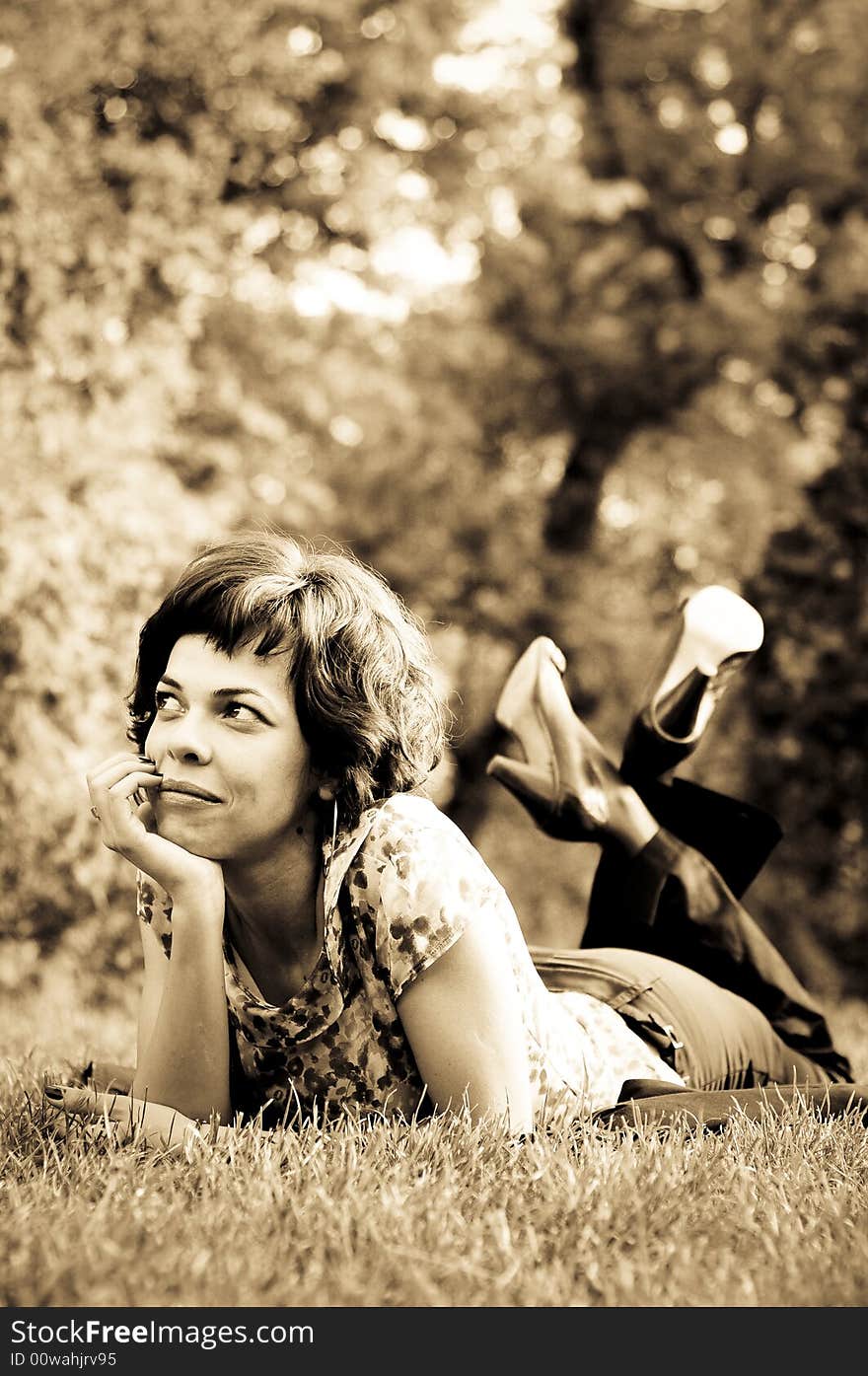 Young woman laid in grass