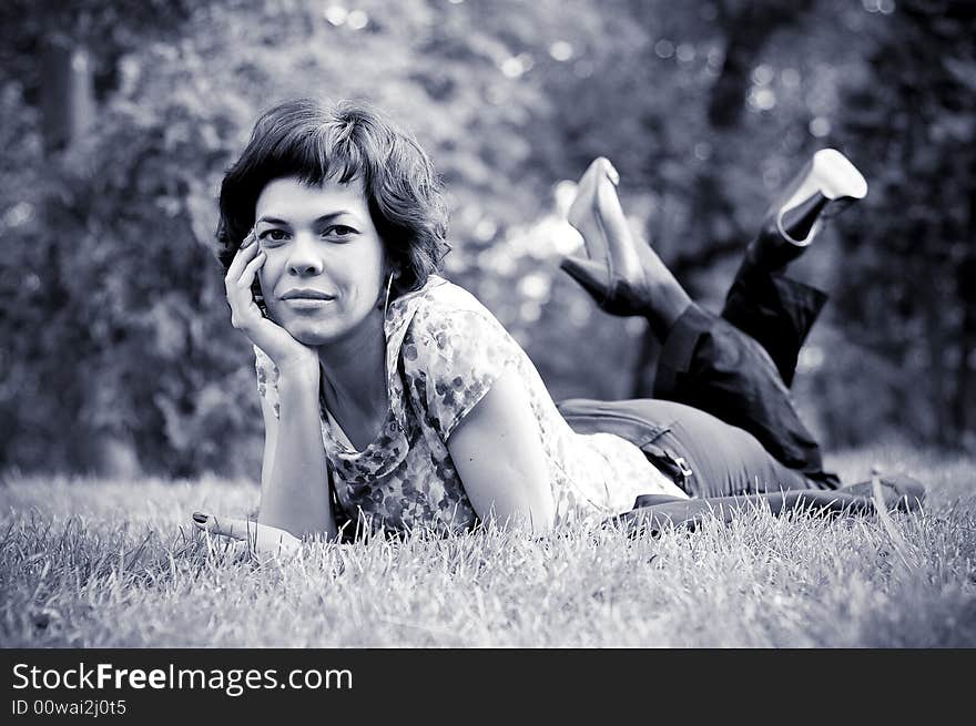 Young woman laid in grass