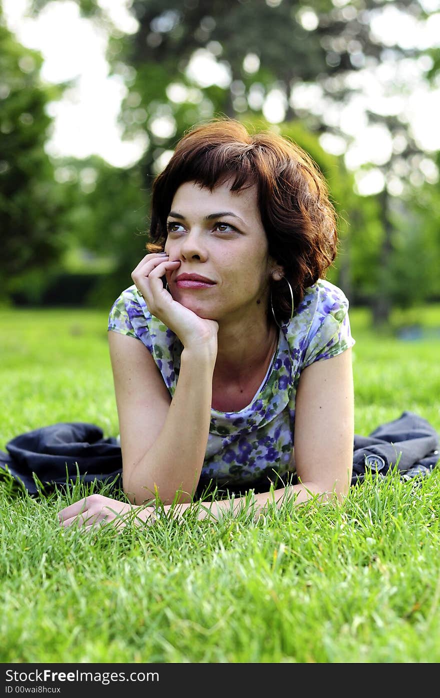 Young woman laid in grass. Young woman laid in grass