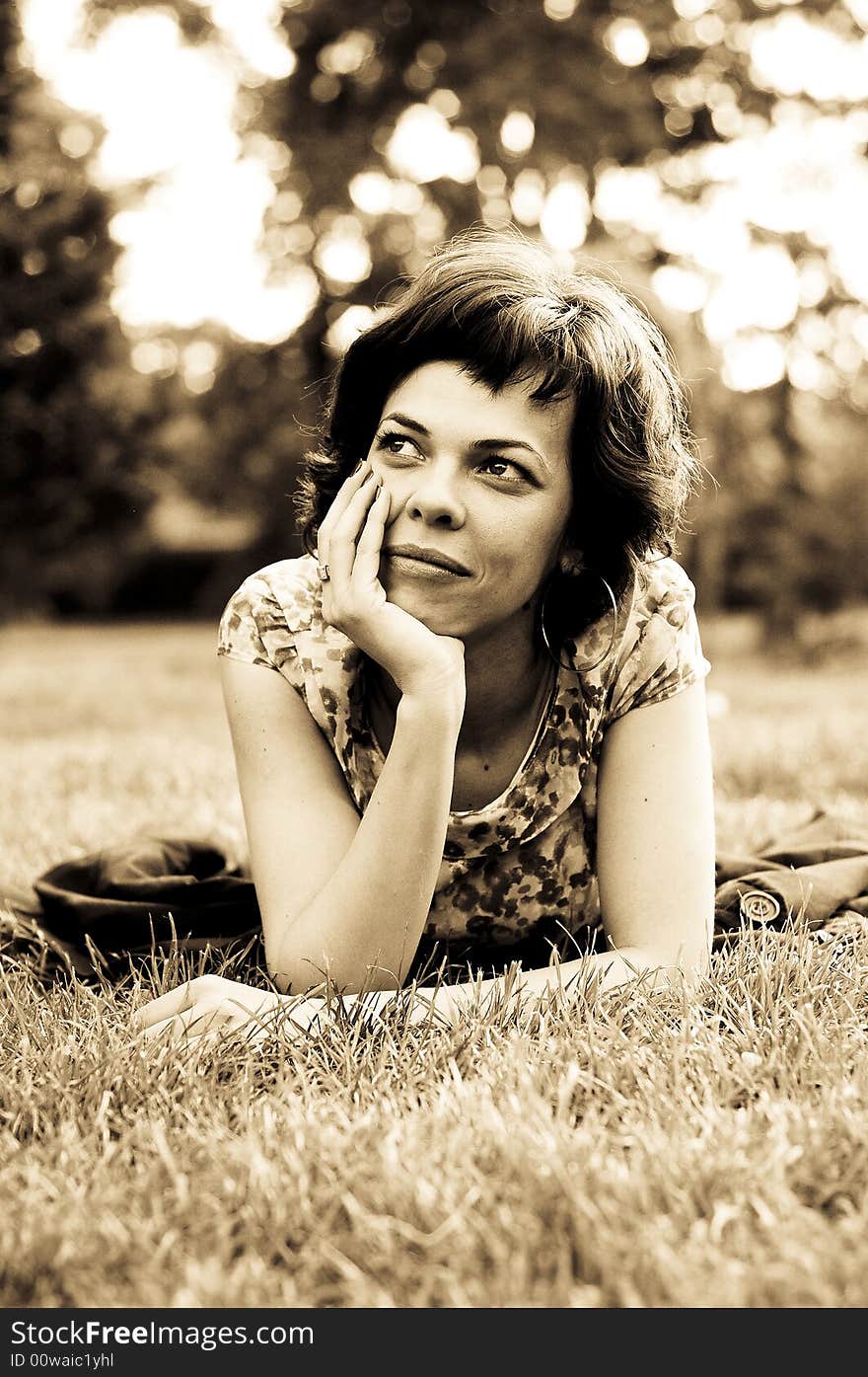 Young woman laid in grass