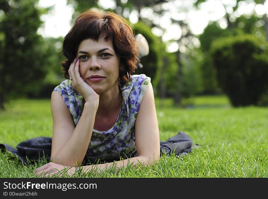 Young woman laid in grass. Young woman laid in grass