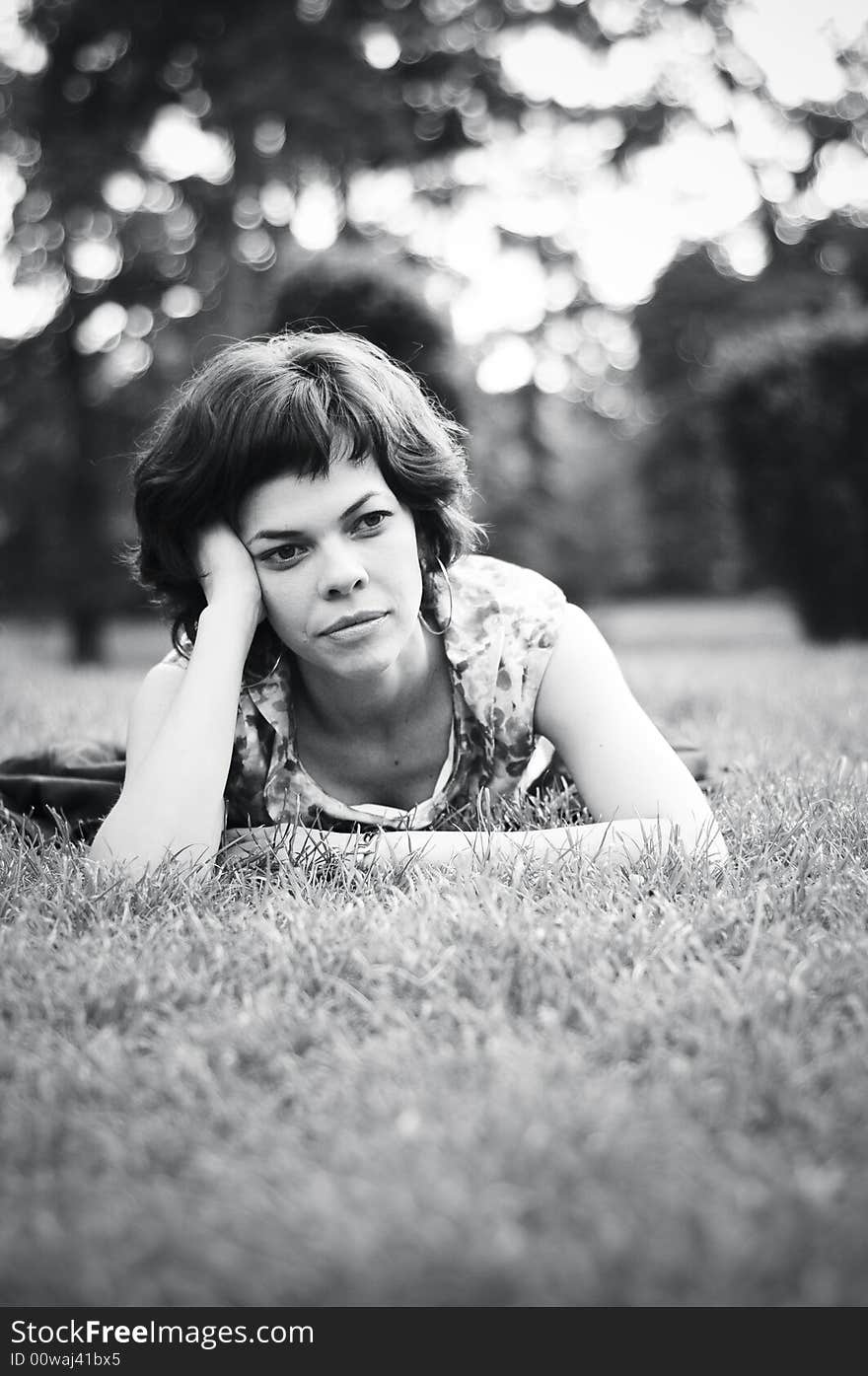 Young woman laid in grass