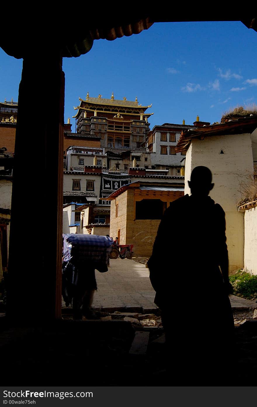 A Lama is walking into Songzanlin Monastery, Shangrila, Yunnan, China. A Lama is walking into Songzanlin Monastery, Shangrila, Yunnan, China.