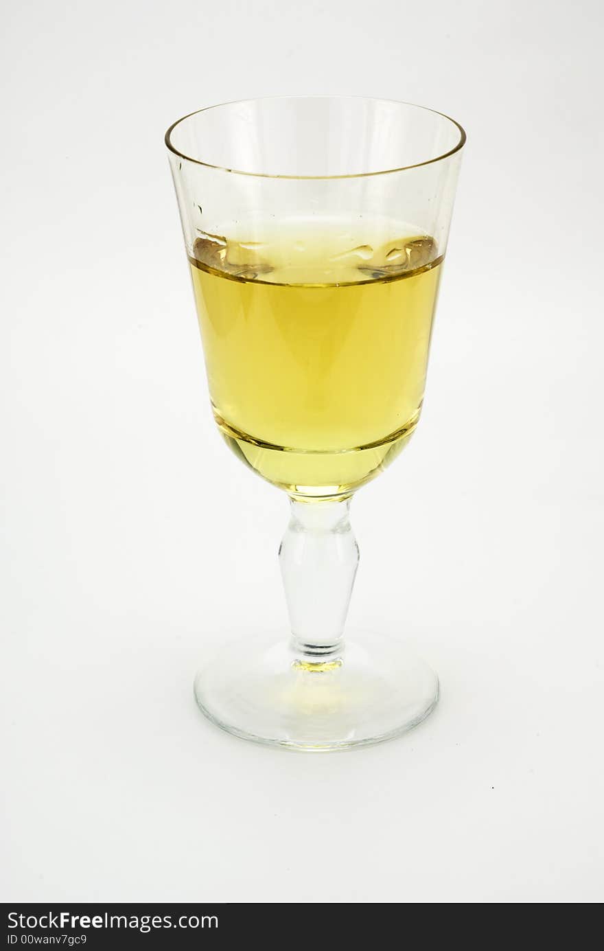 A glass of white wine on white background