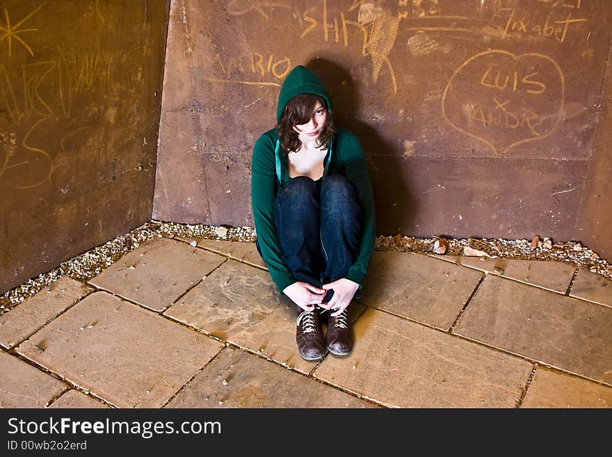 Young woman alone in urban background.