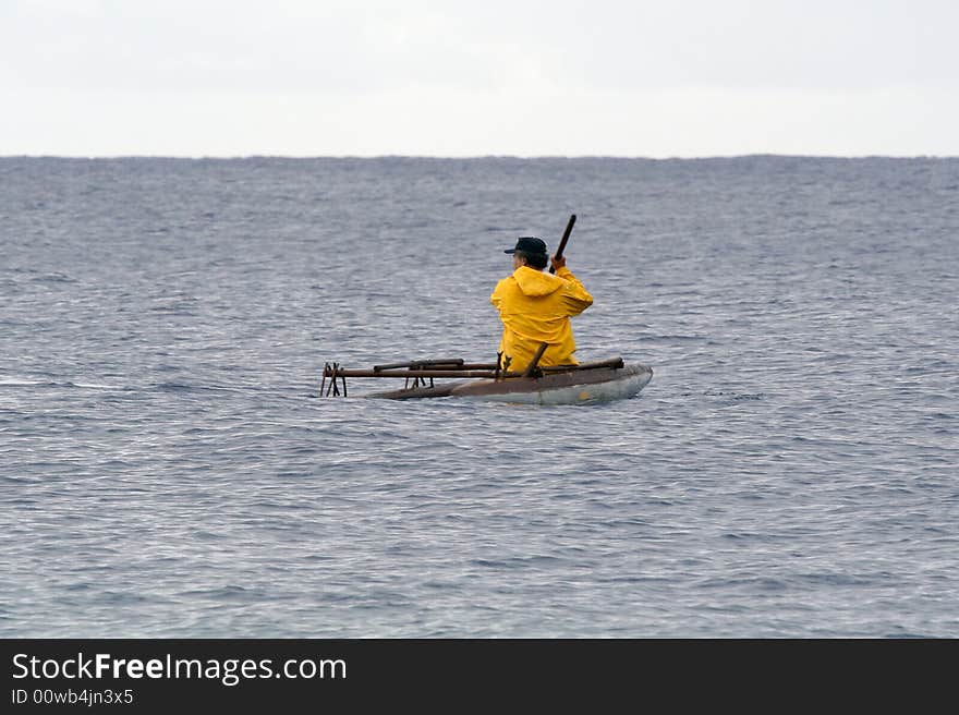 Traditional fisherman setting out in outrigger canoe. Traditional fisherman setting out in outrigger canoe