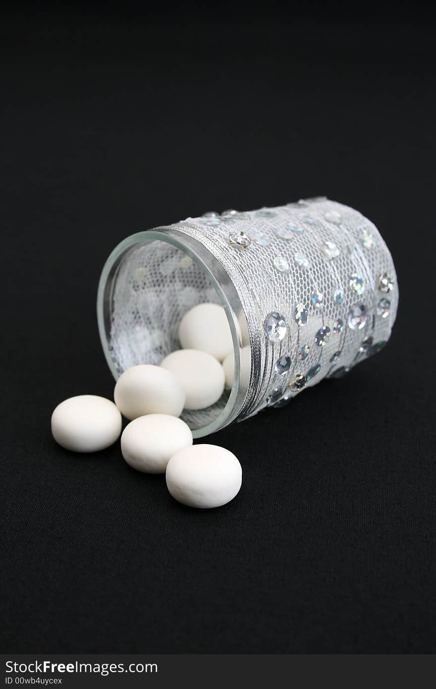 Decorated glass with mints on a black background