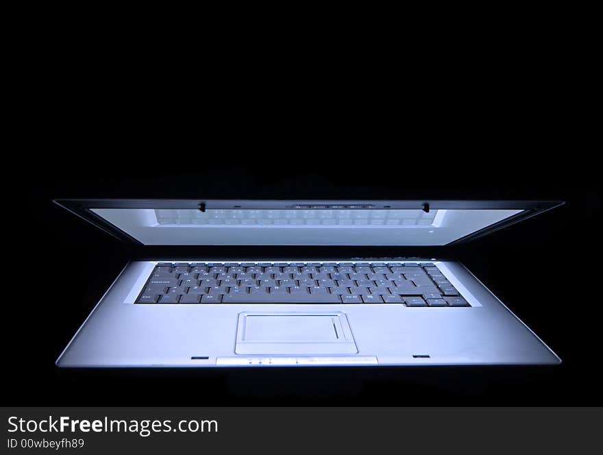 Laptop in a black background using only avaible light. Laptop in a black background using only avaible light