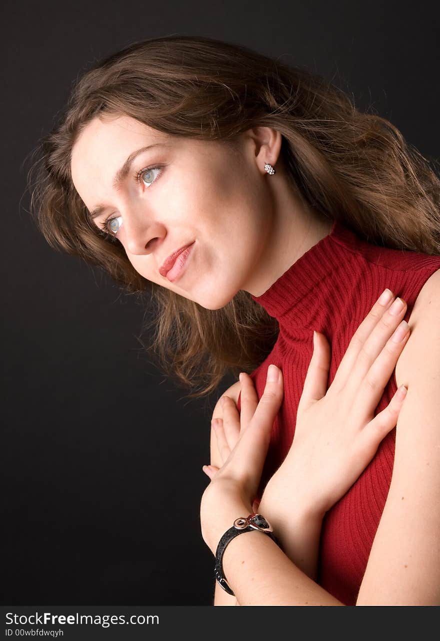 The beautiful girl in studio on a black background.