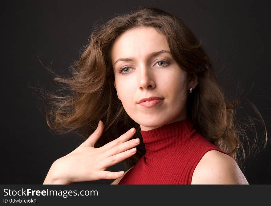 The beautiful girl in studio on a black background.