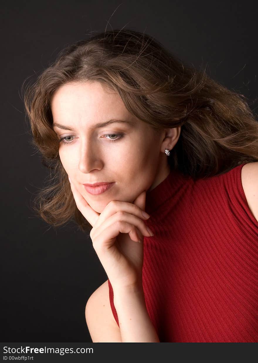 The beautiful girl in studio on a black background.