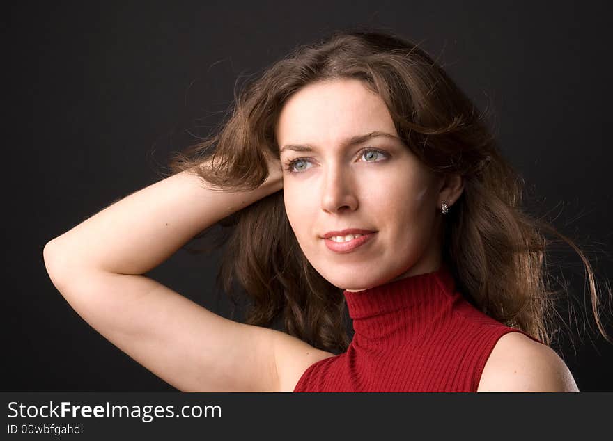 The beautiful girl in studio on a black background.