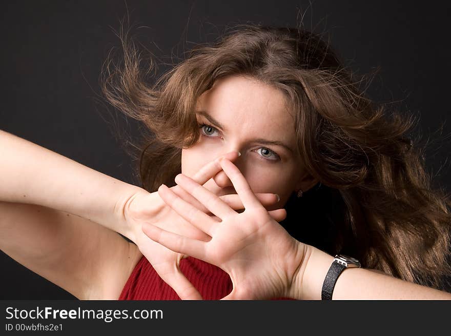 The beautiful girl in studio on a black background.