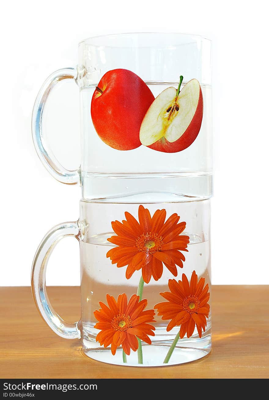 Two transparent cups of water on a table. Two transparent cups of water on a table