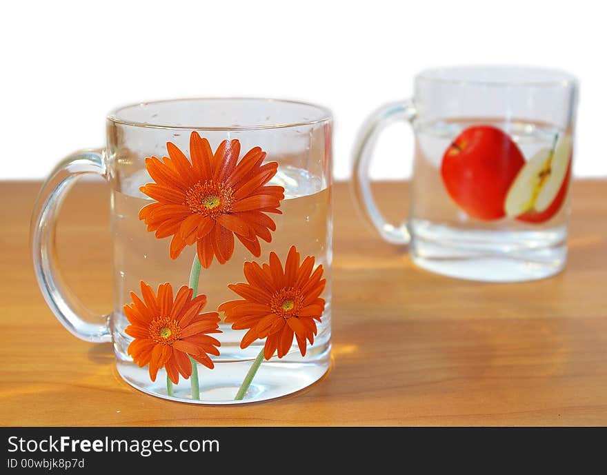 Two transparent cups of water on a table. Two transparent cups of water on a table