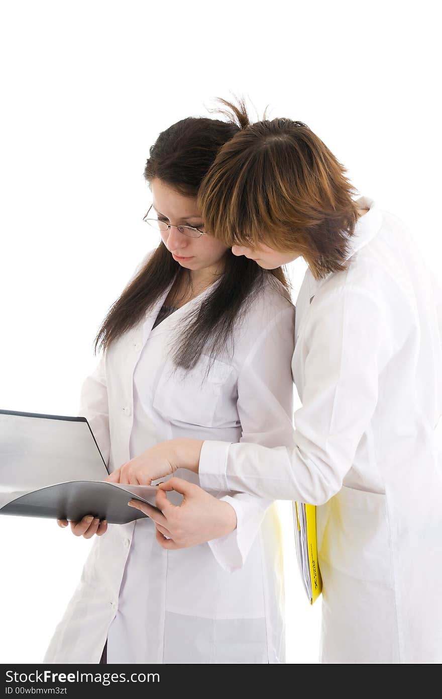 The two young attractive nurse with a folder isolated on a white background. The two young attractive nurse with a folder isolated on a white background