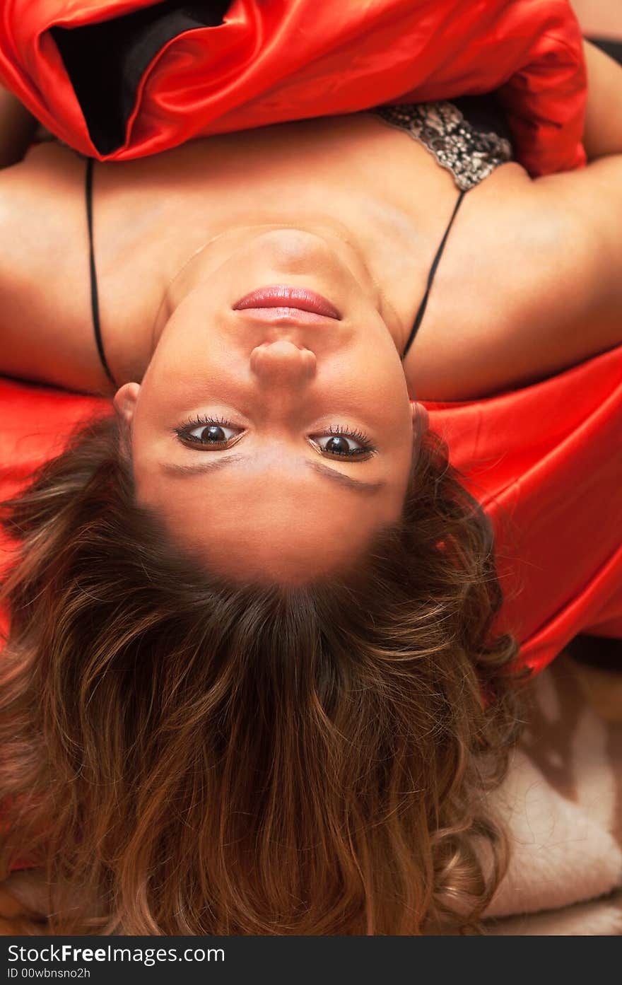 Young sexy girl on red silk bedclothes. Young sexy girl on red silk bedclothes