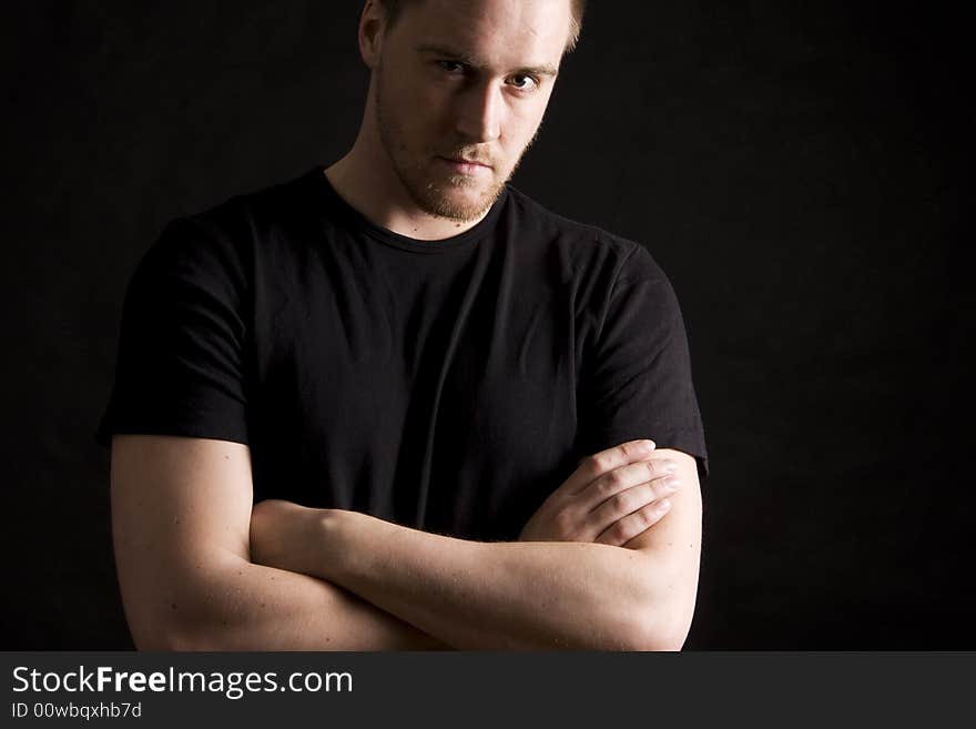 Young man portrait on black background