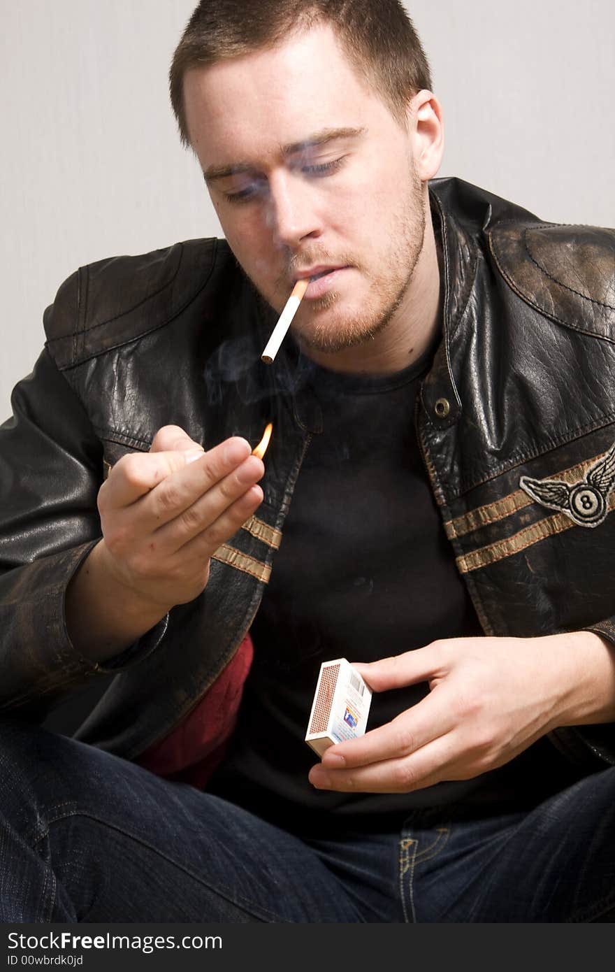 Portrait of young man smoking a cigarette