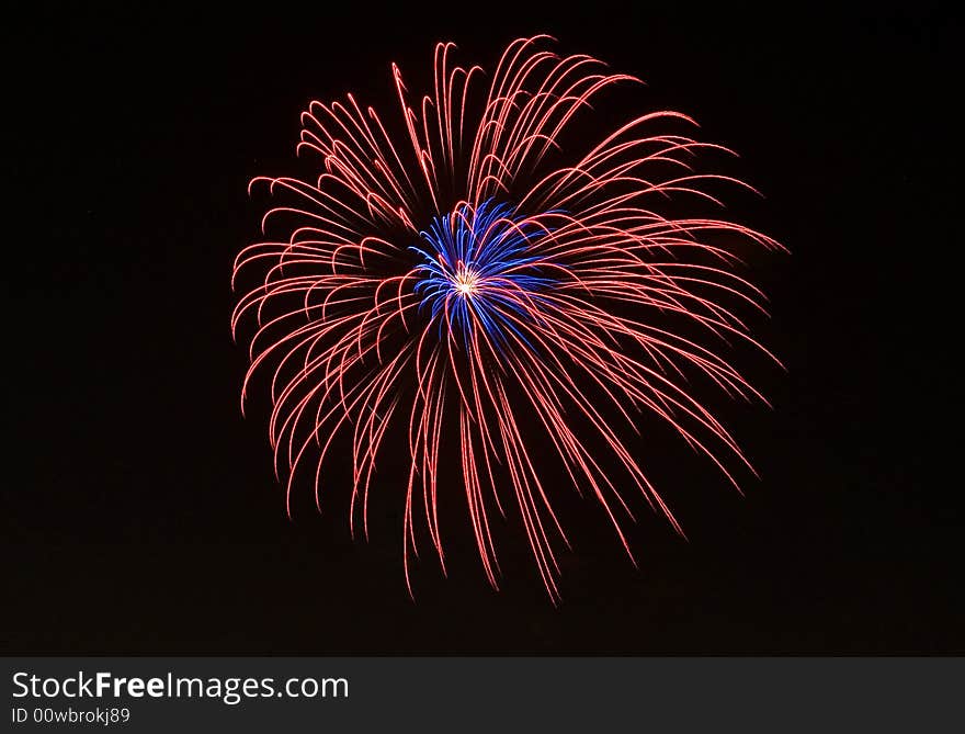 Red and blue fireworks on the black sky