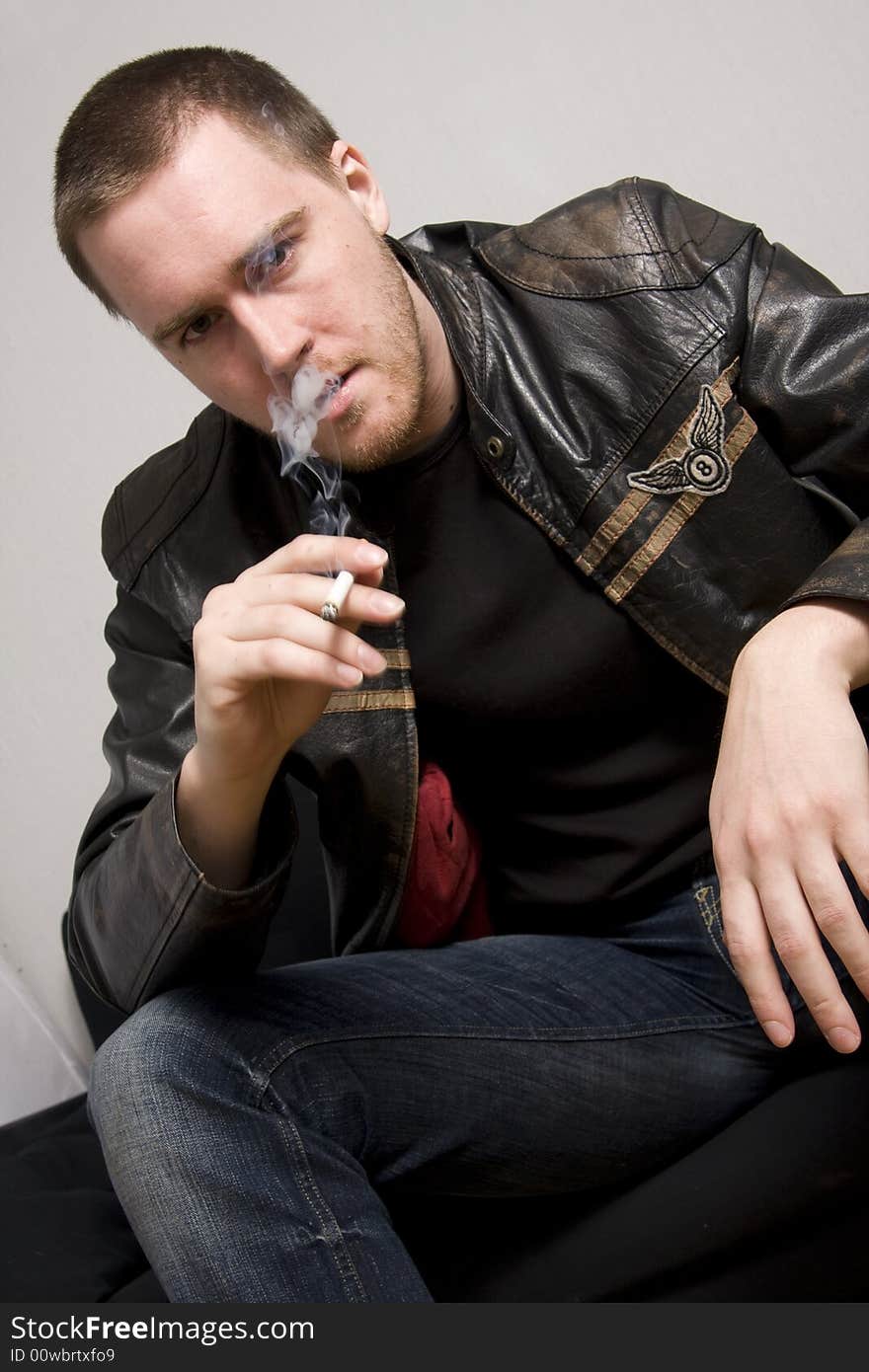 Portrait of young man smoking a cigarette